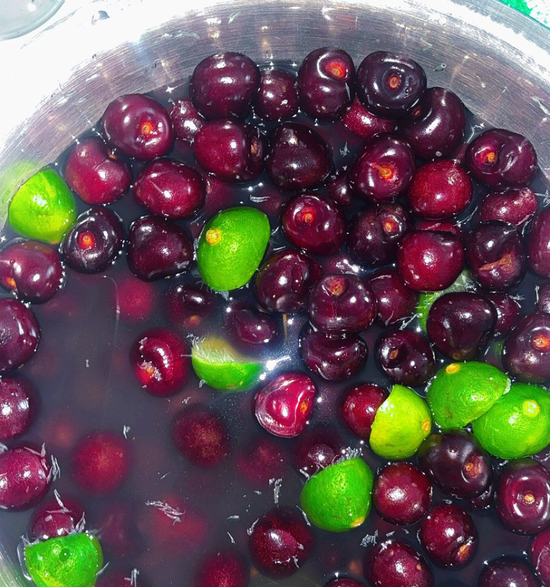 Cherries and limes on a wooden board