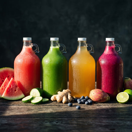 AURA cold-pressed juice by the gallon — four reusable jugs